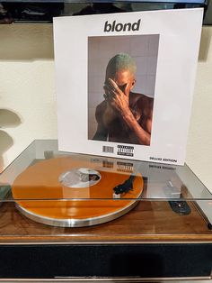 a record player with an orange cover on it's turntable in a display case