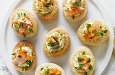 small appetizers are arranged on a white plate