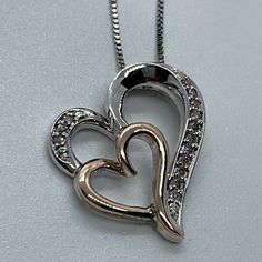 Lovely Sterling Silver 18.5” Long Chain Featuring A Pendant With 2 Hearts Sterling Silver And 14k Rose Gold. The Large Sterling Silver Heart Has 14 Round Shape Natural Diamonds (1/10 Ct. T.W.) It Weights Approximately 4.35 Grams. In New Condition With Box And Pouch. Formal Heart Cut Rose Gold Necklace, Rose Gold Heart Necklace With Diamond Accents, Rose Gold Double Heart Jewelry For Formal Occasions, Formal Double Heart Rose Gold Jewelry, Rose Gold Diamond Cut Heart Pendant Necklace, Rose Gold Heart Pendant Necklace With Diamond Cut, Rose Gold Heart Cut Necklace For Anniversary, Rose Gold Sterling Silver Double Heart Necklace, Rose Gold Heart Pendant Jewelry With Diamond Cut