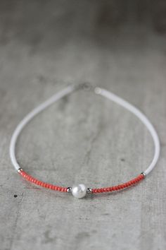 This beautiful dainty choker necklace was made of white seed beads, tiny peach pink crystal beads, one pearl coated glass 10 mm bead, stainless steel separators, silver tone base clasps, strong nylon double thread, silver tone lobster claw and stainless steel adjustable length chain. Perfect jewelry for the summer, especially like a beach necklace! The length of necklace is 41 cm or about 16.1 inches and 4.5 cm of adjustable length chain. Other necklaces you can find in my store in the necklace White Pearl Jewelry With Tiny Beads, White Pearl Chain Beaded Necklace, Delicate White Beaded Necklaces With Tiny Beads, Minimalist White Pearl Beaded Necklaces, White Pearl Necklace With Tiny Beads For Wedding, Delicate White Beaded Necklace, Adjustable White Dainty Pearl Necklace, Delicate White Beaded Necklace With Tiny Beads, Delicate White Pearl Beaded Necklaces