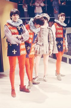 three young men standing next to each other in orange pants