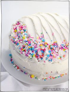 a white frosted cake with sprinkles on it