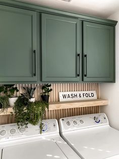 a washer and dryer in a room with green cabinets