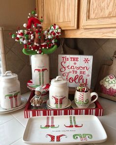 a kitchen counter topped with dishes and christmas decorations