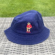 Vintage Navy/White/Beige/Black Polo Bear Bucket Hat Iconic embroidered Fisherman Polo Bear image wearing a cute blue bucket hat 🧸 Diameter of the inside of the hat is roughly 22-24in varying slightly with each hat One size fits all, perfect for festivals, raves or any event where you need to look like a baller Free Shipping Included with every purchase 🚀 No returns on sizing issues Casual Wide Brim Bucket Hat With Embroidered Logo, Casual Brimmed Bucket Hat With Embroidered Logo, Casual Wide Brim Hat With Embroidered Logo, Casual Bucket Hat With Embroidered Logo, Casual Bucket Hat With Embroidered Logo And Short Brim, Blue Cotton Bucket Hat For Outdoor, Wide Brim Hat With Embroidered Logo For Outdoor, Casual Navy Bucket Hat With Short Brim, Navy Casual Bucket Hat With Short Brim