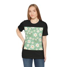 Made with soft cotton, this shirt features a charming daisy flower pattern on a refreshing spring mint green background. Embrace the joys of spring in style and comfort. This classic unisex jersey short sleeve tee fits like a well-loved favorite. These soft cotton t-shirts have-ribbed knit collars to bolster shaping. The shoulders are tapered for a better fit over time. Dual side seams hold the garment's shape for longer. .: Made with 100% Airlume combed and ring-spun cotton, a lightweight fabri Green Casual T-shirt For Spring, Casual T-shirt With Daisy Print For Spring, Light Green Short Sleeve Tops For Spring, Summer Daisy Print Short Sleeve T-shirt, Spring Daisy Print Relaxed Fit T-shirt, Relaxed Fit Daisy Print T-shirt For Spring, Spring Daisy Print Graphic Tee, Spring Daisy Print Short Sleeve T-shirt, Short Sleeve T-shirt With Daisy Print For Spring