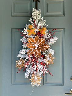 Want to see what it would look like on your door before purchasing? Message me a picture of your empty door and I can show you an example! This beautiful swag will be the perfect touch for your door, double doors, columns, wall, etc. Made with quality faux flocked pine, large gingerbread poinsettia, gingerbread snowflakes, gingerbread bow and girl, flocked branches, red glitter berries, and red crabapples. Hangs easily.  Bow available in many more options! Please note your color choice in the notes section upon checkout (Ex- YES, burlap bow) 30" length shown, available in 30" and 48" Approx 14" wide and 6" deep. If you would like a custom size, color/flower, or have any questions, please message me! All items are packed with care. Looking for a different theme, size or matching items? Mess Gingerbread Poinsettia, Gingerbread Snowflakes, Swag Christmas, Christmas Swag, Door Hanger Wreath, Hanger Wreath, Burlap Bow, Burlap Bows, Christmas Swags