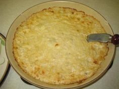 a pie sitting on top of a pan with a knife in it's center