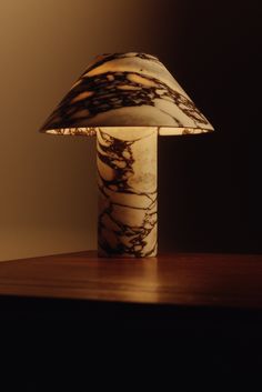 a marble lamp sitting on top of a wooden table