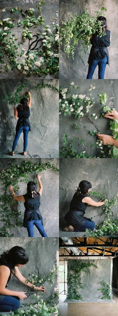 a woman is climbing up the side of a rock wall with vines growing on it