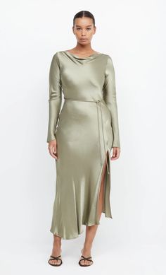 A stylish option for a cool weather wedding, the long sleeve maxi dress is cut on the bias with a cinched tie waist to create a flattering hourglass silhouette. The midi dress features a slight cowl on the high neckline with a low scoop back and leg split in the skirt. Elegant Long Sleeve Bias Cut Maxi Dress, Fitted Bias Cut Maxi Dress For Brunch, Formal Long Sleeve Midi Dress With Side Slits, Belted Midi Dress For Wedding, Fitted Belted Maxi Dress For Brunch, Belted Long Sleeve Maxi Dress For Night Out, Sleek Long Sleeve Midi Dress For Dinner, Chic Long Sleeve Bias Cut Dress, Long Sleeve Bias Cut Maxi Dress For Wedding