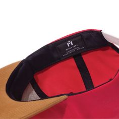 The Third is a classic six-panel, baseball-style cap in red with a contrasting camel brim and flat embroidery detail in white. All March Caps feature top eyelets and an adjustable snap-back closure. Each cap comes with a hand-numbered card signed by the designer. Red Six-panel Snapback Hat For Baseball Season, Red Six-panel Trucker Hat For Streetwear, Red Adjustable Snapback Hat Six-panel, Red Snapback Cap With Logo Patch, Red Adjustable Six-panel Snapback Hat, Red Adjustable Six-panel Baseball Cap, Red Snapback Trucker Hat With Logo Patch, Red Snapback Hat With Logo Patch, Red Snapback Hat With Logo Patch For Streetwear