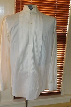 Label: Georgio Patrino Likely 90's or newer cotton/poly formal shirt with wing tip collar and small wale bib - shirt has convertible bib buttons and cuffs (you can use cufflinks and shirts studs or just use the buttons) Size    Neck: 15 / Chest: 42-44 / Sleeve: 24" / Across Shoulder Seams: 17" Condition:  Excellent  AMERICAN VINTAGE CLASSICS RST044 Formal Cotton Shirt With Covered Buttons, Formal Tops With Fold Down Collar And Placket, Formal Collared Tops With Buttons, Classic Formal Tops With Covered Buttons, Formal Collared Top With Placket, Formal Tops With Spread Collar And Placket, Business Tuxedo Shirt With Long Sleeves, Formal Tuxedo Dress Shirt With Long Sleeves, Formal Button-up Tops With Covered Buttons