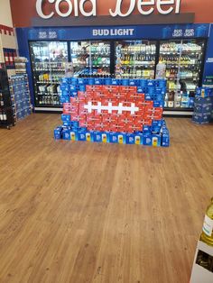 a store filled with lots of coolers and drinks in front of the cold beer aisle