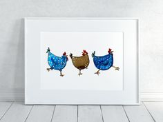 two chickens are standing next to each other in a white frame on a wooden floor