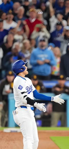 a baseball player is about to swing his bat at the ball in front of an audience