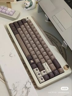 a computer keyboard sitting on top of a white desk next to a mouse and keyboard