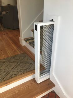 an open door on the side of a stair case next to a carpeted floor