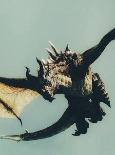 a large black dragon flying through the sky