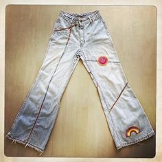 "FADED GLORY Description: Vintage 70s Patched Bell Bottom Lightweight Denim Jeans. Velvet 70s Patches: Smiley Face, Rainbow. Zipper Fly. Super Soft and Distressed Denim. Label: Faded Glory. NOTE: Distressed Leather Piping. Spattered Stains. Measurements: Waist: 13\" Across, (26\" Around). Length/Inseam: 28\" Bell Bottom: 11\" Across, (22\" Around). For best fit, please compare measurements with a pair of jeans of your own. SUPER SOFT LIGHTWEIGHT PATCHED PERFECTION. Circa 1970s. Excellent Vintage Condition. 100% Cotton. OOAK (one-of-a-kind). Made in USA. PLUS: All clothes are washed, ironed and ready-to-wear!" Retro Distressed Bottoms For Spring, Retro Denim Bottoms For Festival, Vintage Bleached Faded Bottoms, Vintage Relaxed Fit Summer Flare Jeans, Vintage Relaxed Fit Flare Jeans For Summer, Spring Retro Distressed Bottoms, Vintage Medium Wash Bottoms For Festival, Vintage Flare Jeans With Frayed Hem For Spring, Spring Vintage Flare Jeans With Frayed Hem