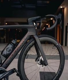 a close up of a bike parked in front of a building with no people on it