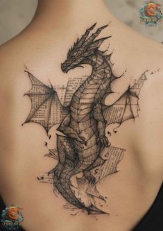 a woman's back with a dragon tattoo on it