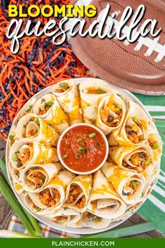 a plate filled with tacos and sauce next to a football