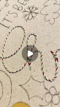 a close up of a piece of fabric on a table cloth with scissors and thread