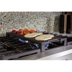 two pita breads sit on the burners of an electric stove in a kitchen