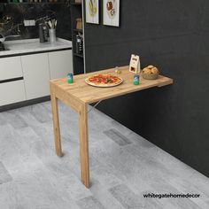 a table with a pizza on it in the middle of a kitchen next to a counter