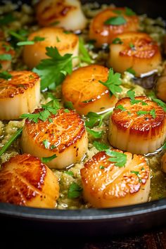 some scallops are cooking in a skillet