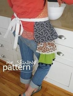 a woman standing in front of a kitchen counter with a bowl on it's side