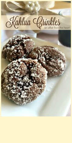 three chocolate crinkles on a white plate with the words kahlua crinkles