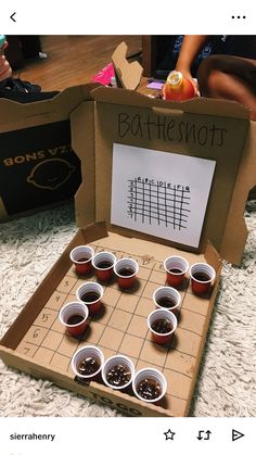 an open box with some cups on top of it and the words bottleshots written in