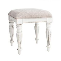 a white vanity stool with a beige upholstered seat