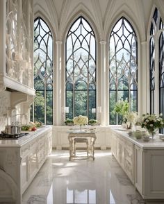 an elegant kitchen with large windows and marble counter tops