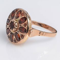 Handmade 14K Rose Gold Ring with Garnet Oval Flower Shape Garnet is a stone of regeneration and energizing it can boost energy. It is said to be stabilizing in that it can bring order to chaos whether internal or external. Details and Measurements: ► 14 Karat Rose Gold ► Size 7.5 (select your size) ► Central Garnet 5 mm ► 8 Garnet stones 5x3 mm ► 8 Garnet stones 1.75 mm ► Total Weight 7.7 gr All items are Handmade, I pay a lot of attention to every piece. All of my items are hand crafted in Kisu Luxury Rose Gold Garnet Jewelry, Oval Multi-stone Garnet Rings, Heirloom Oval Flower Ring Hallmarked, Victorian 14k Gold Cluster Ring With Gemstone, Heirloom 14k Gold Flower Ring With Gemstone, Antique 14k Gold Round Flower Ring, Antique Round Flower Ring In 14k Gold, Victorian Hallmarked Flower Ring, Heirloom Garnet Ring