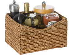 a wicker basket with spices and condiments in it