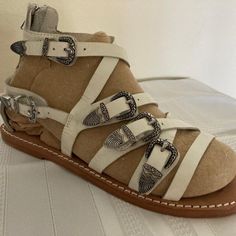 Roman Looking Sandals By Ash. European Size 37 Will Fit American Sizes 6-7. Unworn. Leather Soled. Most Straps Adjustable. Foot Enters At Heel, Then Zips Up. White Leather Sandals For Summer, White Flat Sandals With Heel Strap, White Flat Heel Sandals With Removable Insole, White Sandals With Leather Sole And Round Toe, White Ankle Strap Sandals With Removable Insole, White Open Toe Sandals With Buckle Closure, White Leather Sole Sandals For Vacation, White Leather Sandals For Vacation, White Sandals With Leather Sole For Vacation