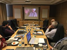 a group of people sitting around a conference table