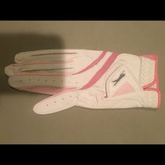 a pair of white and pink gloves sitting on top of a table