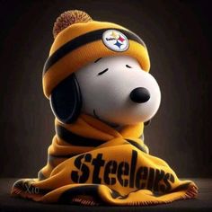 a snoopy dog wearing a yellow and black hat with the pittsburgh football team on it