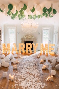 a room filled with lots of white balloons and confetti on top of it