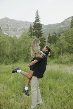 a man carrying a woman on his back in a field