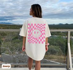 Checkered Retro Smiley Face Lightning Bolt Comfort Colors T-shirt The divine *Comfort Colors T-shirts are made from specially spun fibers of 100% cotton for strength and softness and are pre-washed for that relaxed look and feel we love. 🌸 Please refer to the size chart in the listing images before submitting your order For oversized look, size up 1-3 from your regular size, depending on the look desired. *Compared with other shirt brands, Comfort Colors are generally thicker and have a larger Smiley Face Lightning Bolt, Retro Smiley Face, Shirts Y2k, Smiley Face Shirt, Color Checker, Preppy Clothes, Clothes Trendy, Y2k Preppy, Vsco Girl