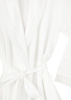 Embracing a European aesthetic of hand embroidery with elegant touches of cotton lace, Jacaranda Living produces a wide variety of high quality luxury linens—for bath, table, sleepwear, and more that feel as good as they look in your home or wardrobe. Swaddle yourself in comfort with the Long Sleeve Cotton Bathrobe with Lace Detail, featuring French lace on the cuffs and a delightfully warming shawl collar. As nice for just out of the bath as it is for some old fashioned lounging. This robe can Elegant Cotton Sleepwear For Spring, Elegant Cotton Sleepwear For Summer, Elegant Cotton Summer Sleepwear, Elegant Summer Cotton Sleepwear, Elegant Lace Trim Robe For Spring, Elegant Summer Lace Robe, Elegant Cotton Robe For Daywear, Elegant Spring Cotton Robe, White Lace Sleepwear For Home