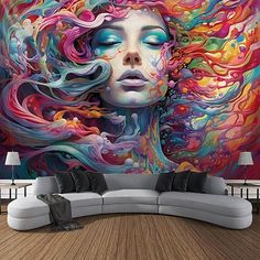 a woman's face is painted on the wall in this living room with colorful art