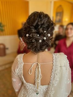 the back of a bride's dress as she gets ready to walk down the aisle