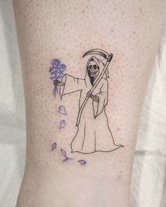 a tattoo on the leg of a woman with a sceptacle holding a blue flower