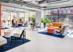 an office with colorful furniture and large windows